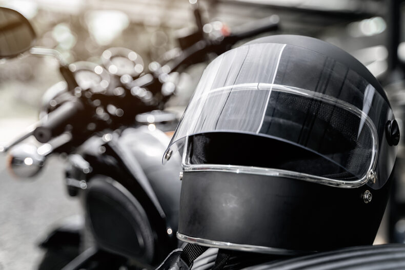 Black motorcycle helmet on top of bike