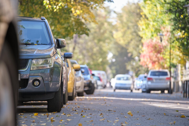 Vehicles parked on the side of a residential street.