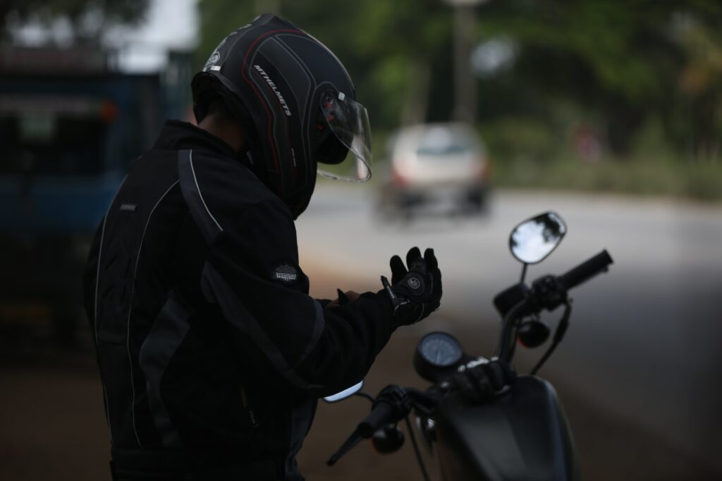 Motorcyclist adjusting gloves