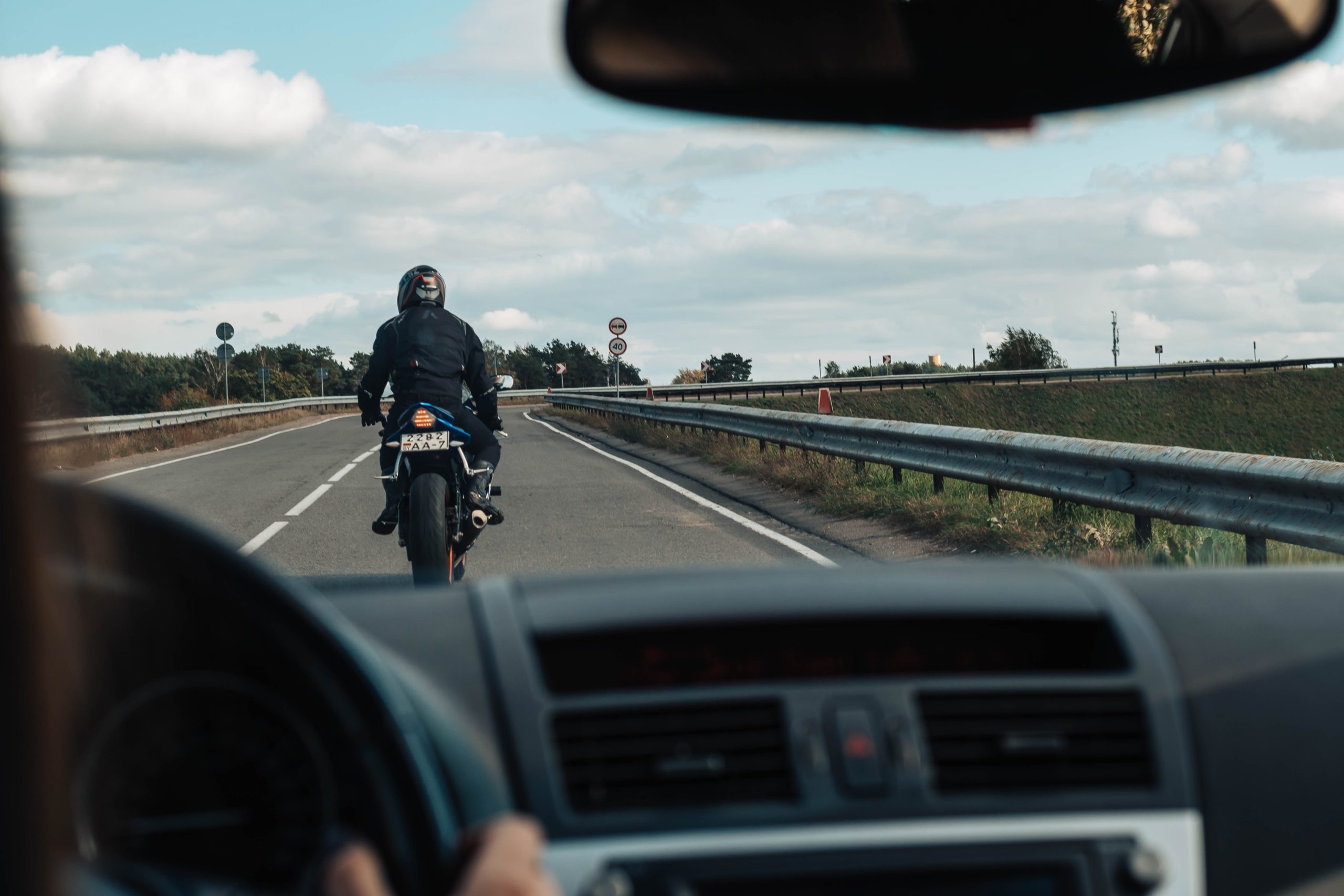View of motorcycle rider from car