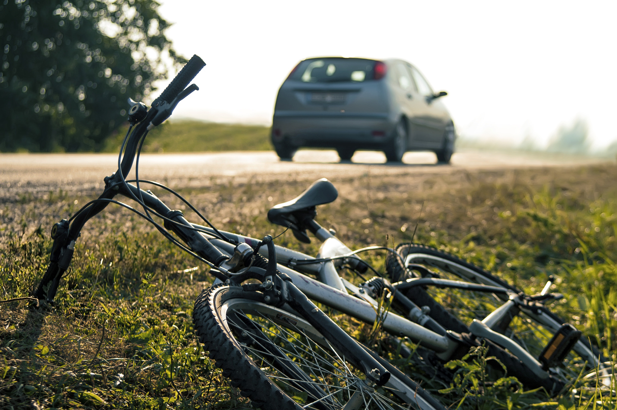 damaged bicycle on the side of the road