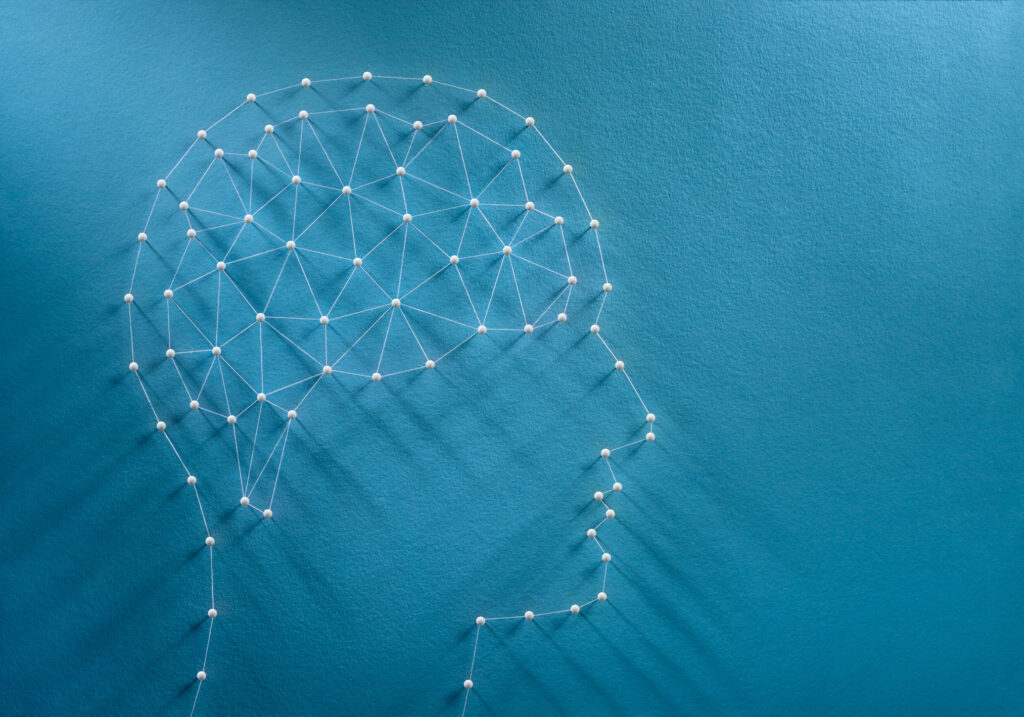 White pins on blue background showing the brain