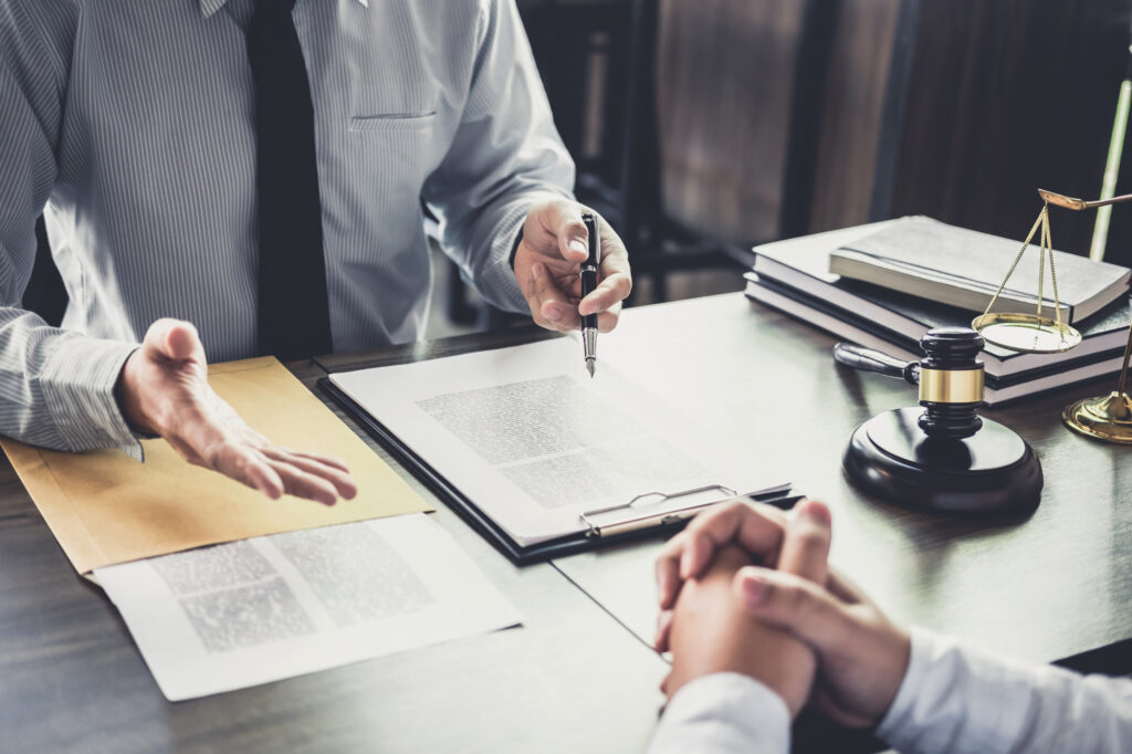 Lawyer talking to client with documents in front of them