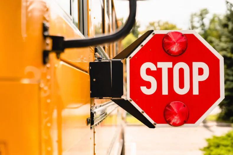 Yellow school bus with stop sign