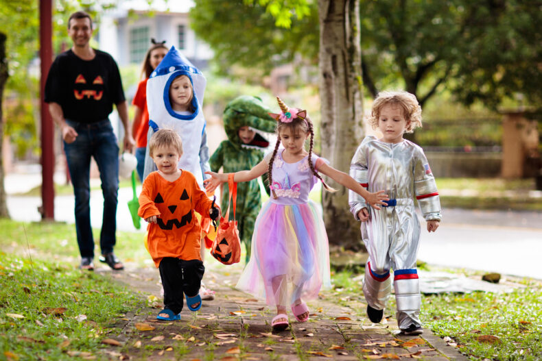 Young children wearing costumes on Halloween