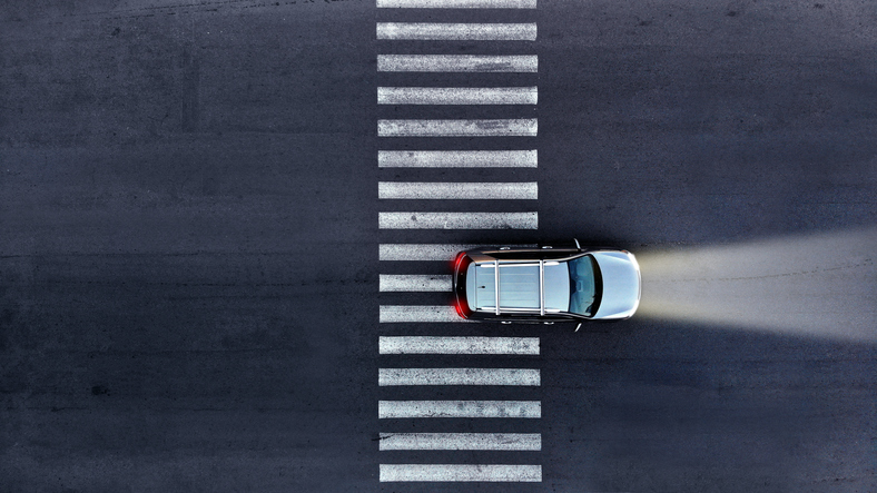 car driving through an empty crosswalk