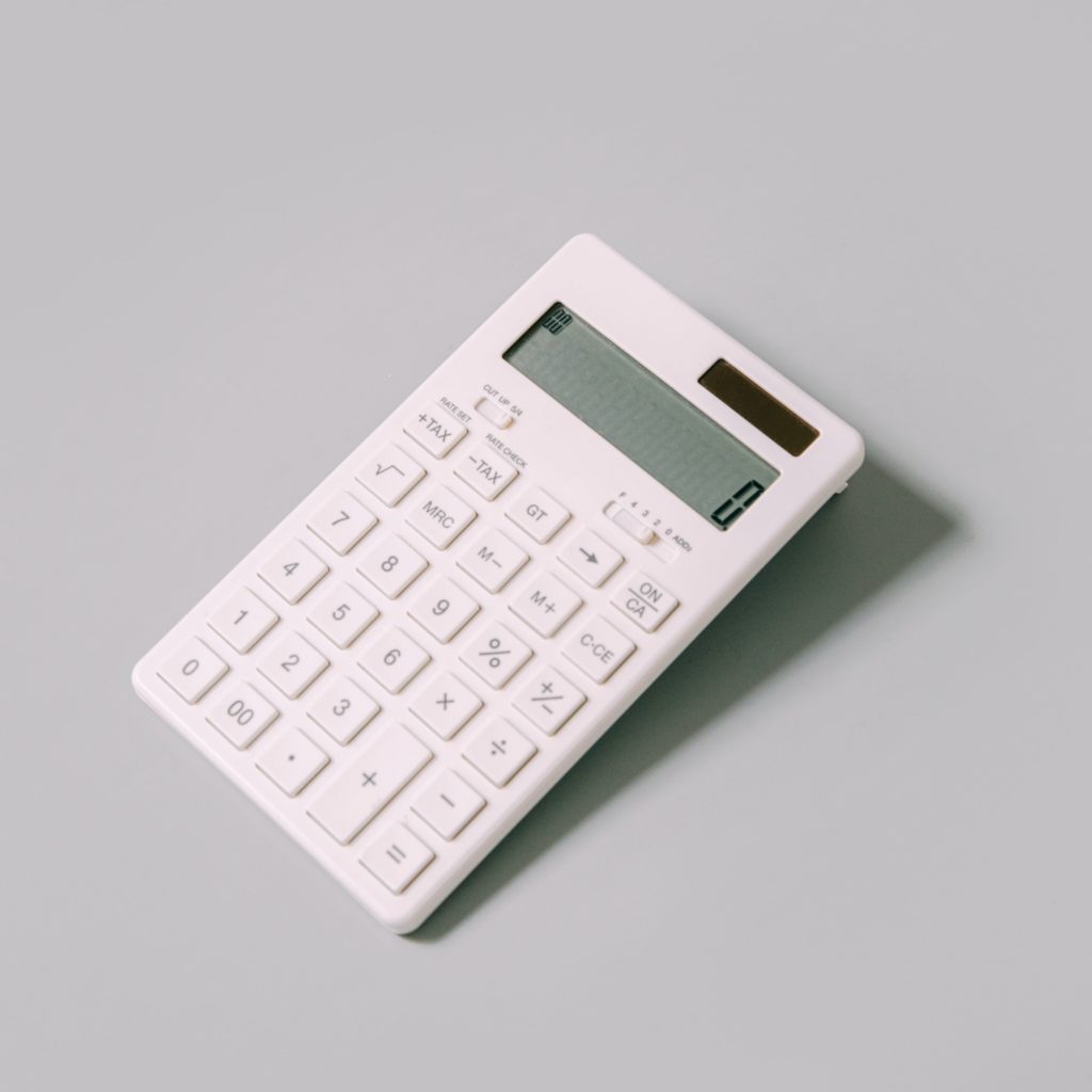 White calculator on a grey background