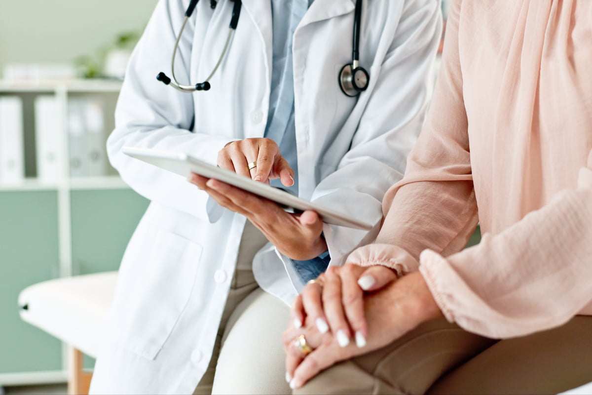 Doctor showing patient a tablet and explaining the results of the medical examination