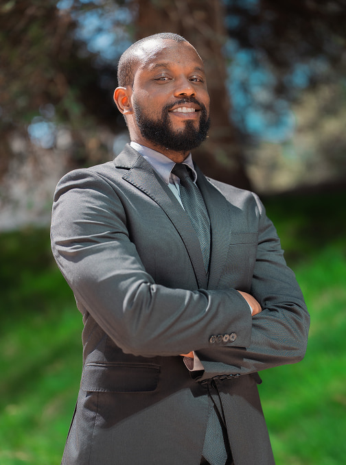 Photo of Attorney Jehrid Mosley standing in front of a tree outside