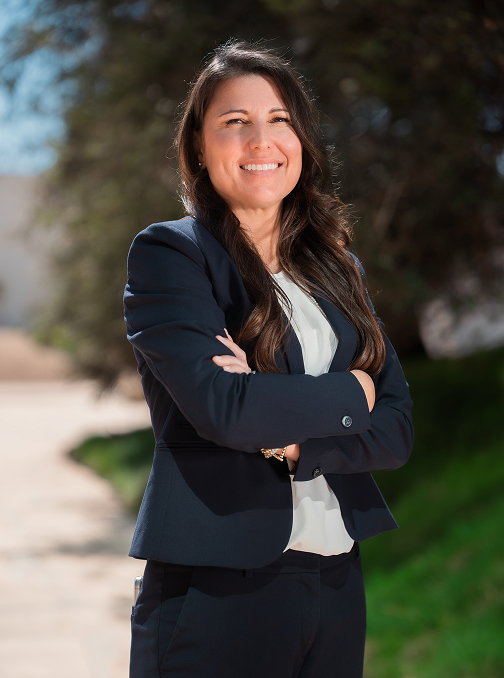 Photo of attorney Kara Nunez outside standing in front of tree