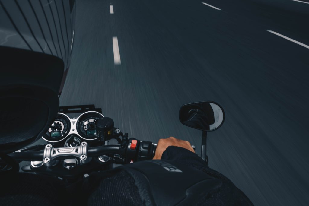 Close-up of a motorcycle rider on the road 