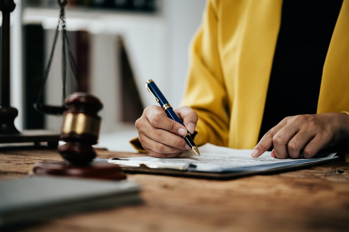 Footage of close of of lawyer and client are discuss and signing on indictment, plaint or appeal.