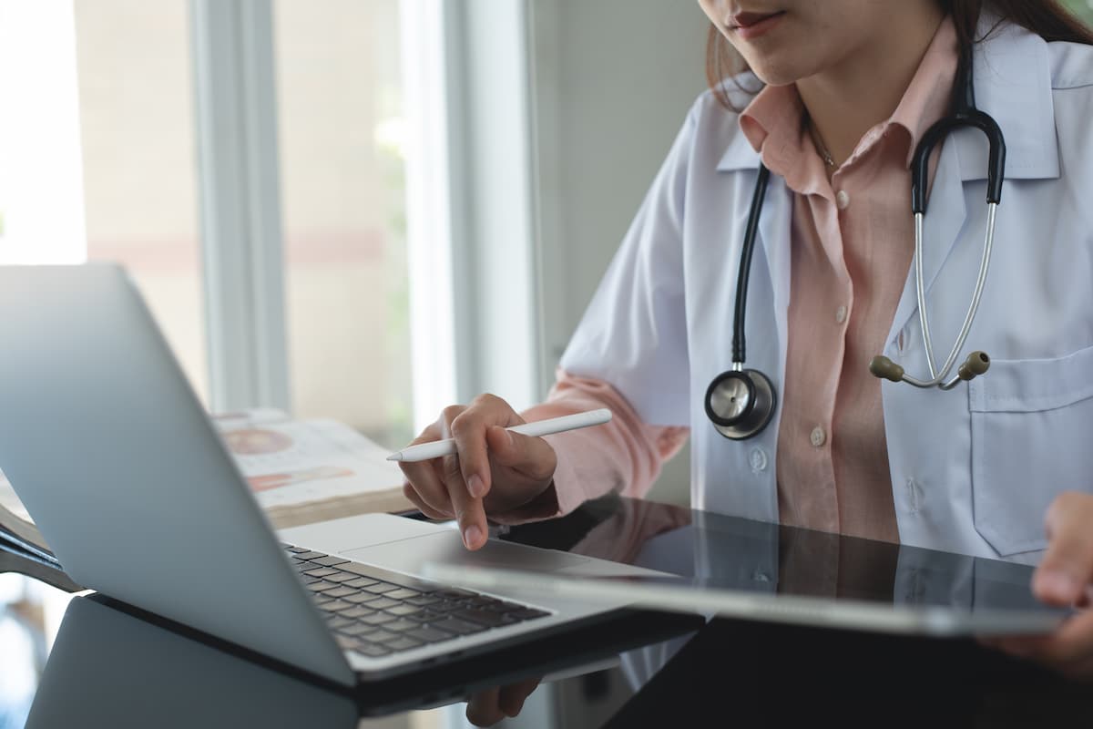 Female doctor working on laptop computer