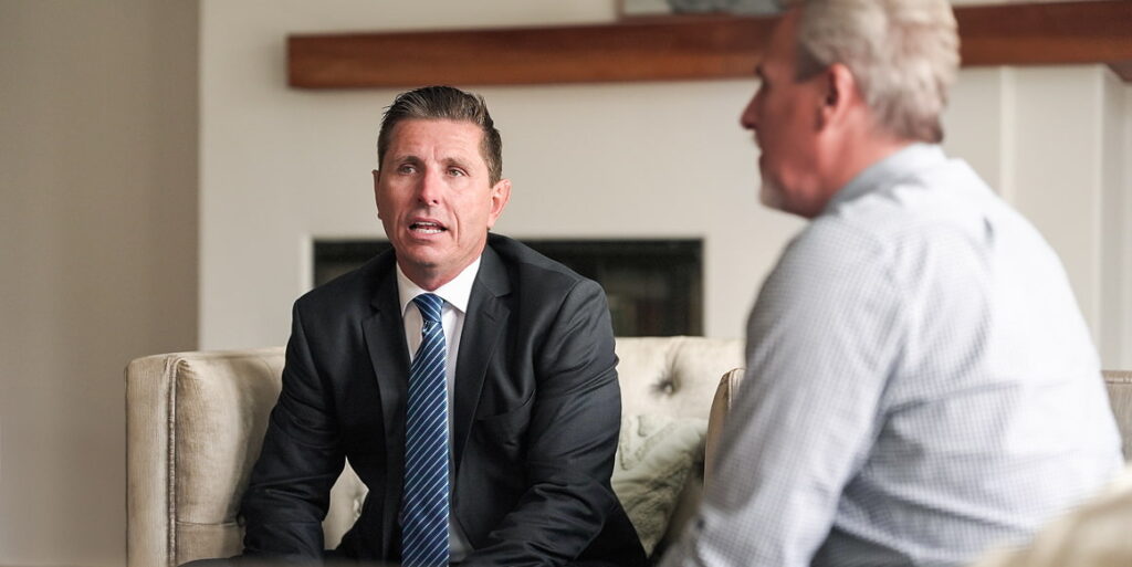 Two men talking in a home setting