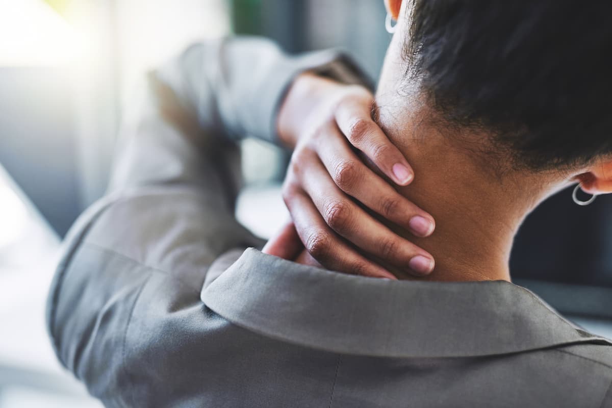 Neck pain, burnout or hands of business woman in office with joint discomfort.