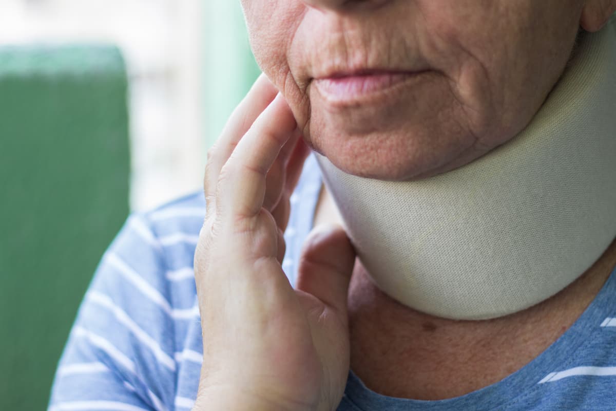 Senior woman wearing neck brace