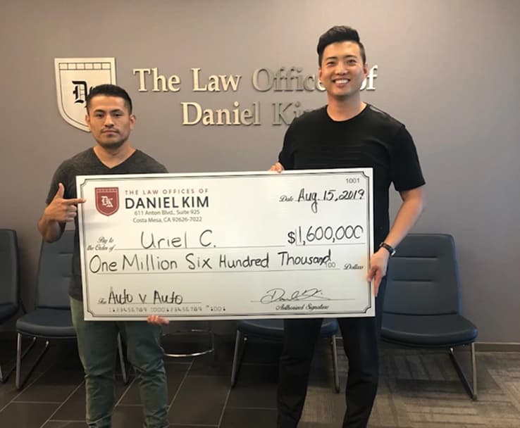 DK Law Client Image with a Jumbo Check of $1,600,000 for an Auto vs Auto Case