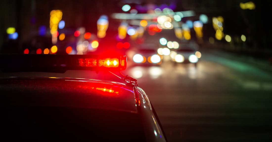 Police car with lights on at night after a drunk driving accident in Los Angeles