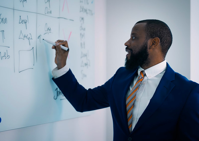 DK Law attorney Jehrid Mosley writing on the board.